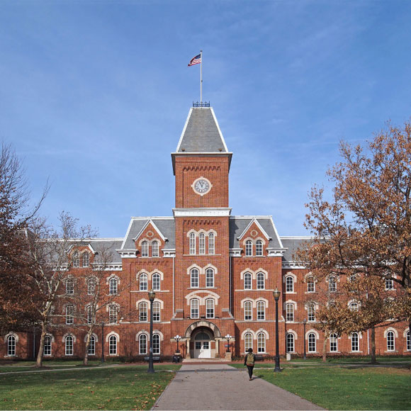 red brick college building with flag on top