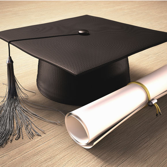 black graduation cap with tassel and rolled scroll