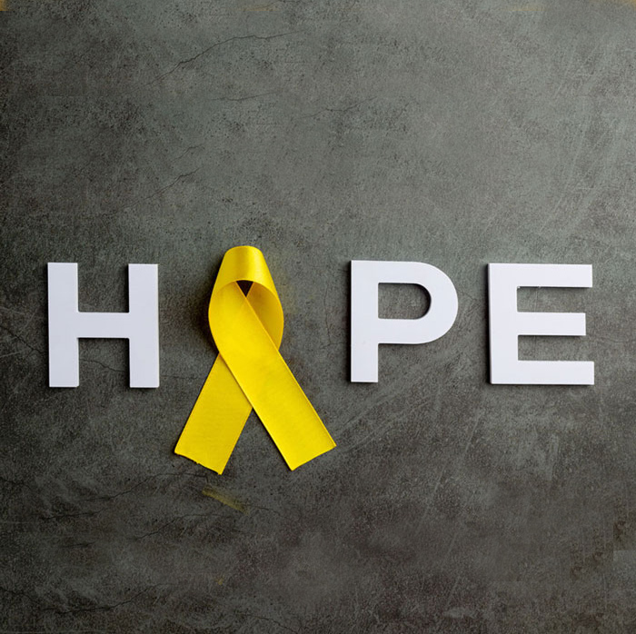 The word hope with a yellow suicide prevention ribbon in place of the letter O